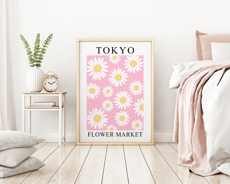 May include: A framed print with a pink background and white daisies. The print says "TOKYO FLOWER MARKET" at the bottom.