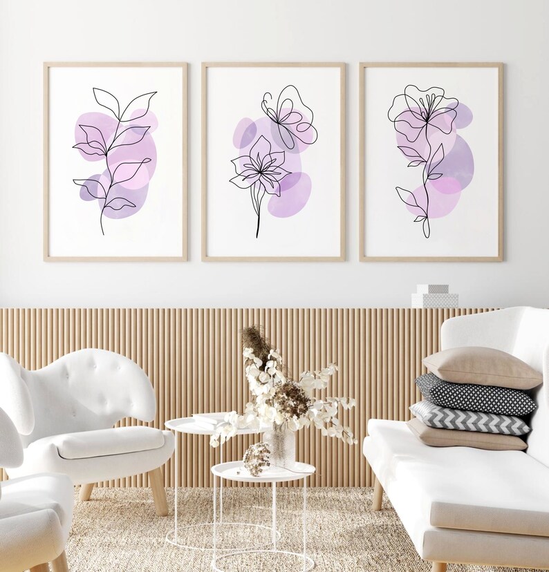 May include: Three minimalist line art prints with purple watercolour accents. The prints feature a butterfly, a flower, and a leafy branch.