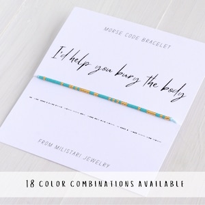 May include: A turquoise and gold beaded bracelet with the message "I'd help you bury the body" written in Morse code. The bracelet is on a white card with the text "Morse Code Bracelet" and "From Miliatari Jewelry".