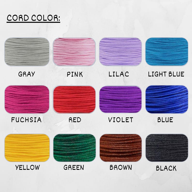 May include: A chart displaying 12 different colours of cord, with the colour name written below each sample. The colours are: grey, pink, lilac, light blue, fuchsia, red, violet, blue, yellow, green, brown, and black.