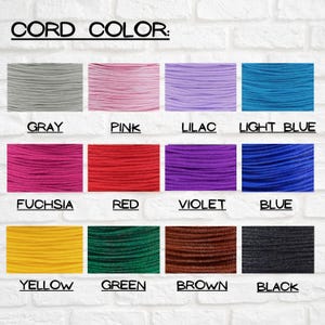 May include: A chart showing 12 different colors of cord, with the color name written below each sample. The colors are: gray, pink, lilac, light blue, fuchsia, red, violet, blue, yellow, green, brown, and black.
