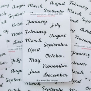 May include: A sheet of white sticker paper with black handwritten month names. The sticker sheet includes all 12 months of the year. The text "Handwritten Month Stickers MO-003 ByJoliecious Etsy Shop" is printed at the top of the sheet.