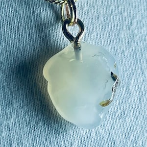 May include: A gold chain necklace with a white agate pendant. The pendant is a natural stone with a smooth, rounded shape.