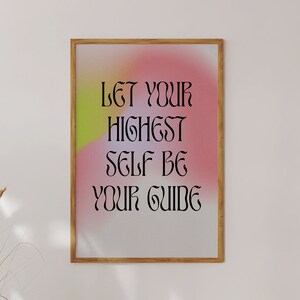 May include: A framed print with a pink and yellow gradient background and the text "Let your highest self be your guide" in black.