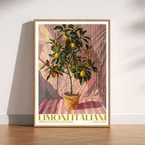 May include: A framed print of a lemon tree in a yellow and blue pot, with a pink and white striped tablecloth underneath. The print has the text "Limoni Italiani" at the bottom, with the words "Limoni della Costiera Amalfitana" and "Gusti il Sole" below that.