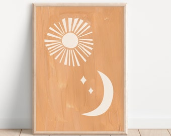 May include: A framed print with a peach background and white sun and moon designs. The sun has rays and the moon has two small stars.