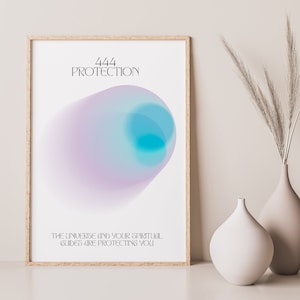 May include: A framed print with a white background and a blue and purple abstract design. The text "444 PROTECTION" is at the top of the print. The text "THE UNIVERSE AND YOUR SPIRITUAL GUIDES ARE PROTECTING YOU" is at the bottom of the print.