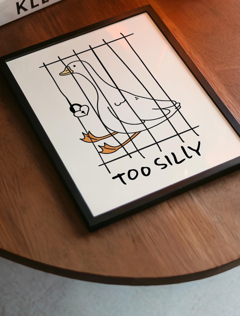 Bring a smile to your space with this Too Silly goose art print! A funny, minimalist illustration featuring a cheeky goose behind bars for being “too silly.” Perfect for adding personality to your home, office, or gallery wall.
This quirky silly goose animal print makes a wonderful gift for friends who love humor, cottagecore whimsy, or modern minimalist art. Designed to brighten up any corner and spark joy daily.