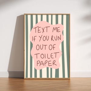 Funny bathroom wall art print with pink blob and wavy green stripes that reads “Text Me If You Run Out Of Toilet Paper”.