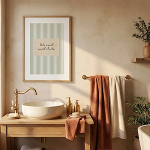 Funny bathroom wall art featuring olive green vertical pinstripes with a distressed cream scalloped label reading “take a seat sweet cheeks” in black handwritten script. Minimal vintage heritage inspired bathroom print with playful typography and a cosy boutique hotel aesthetic for guest bathrooms or powder rooms.
