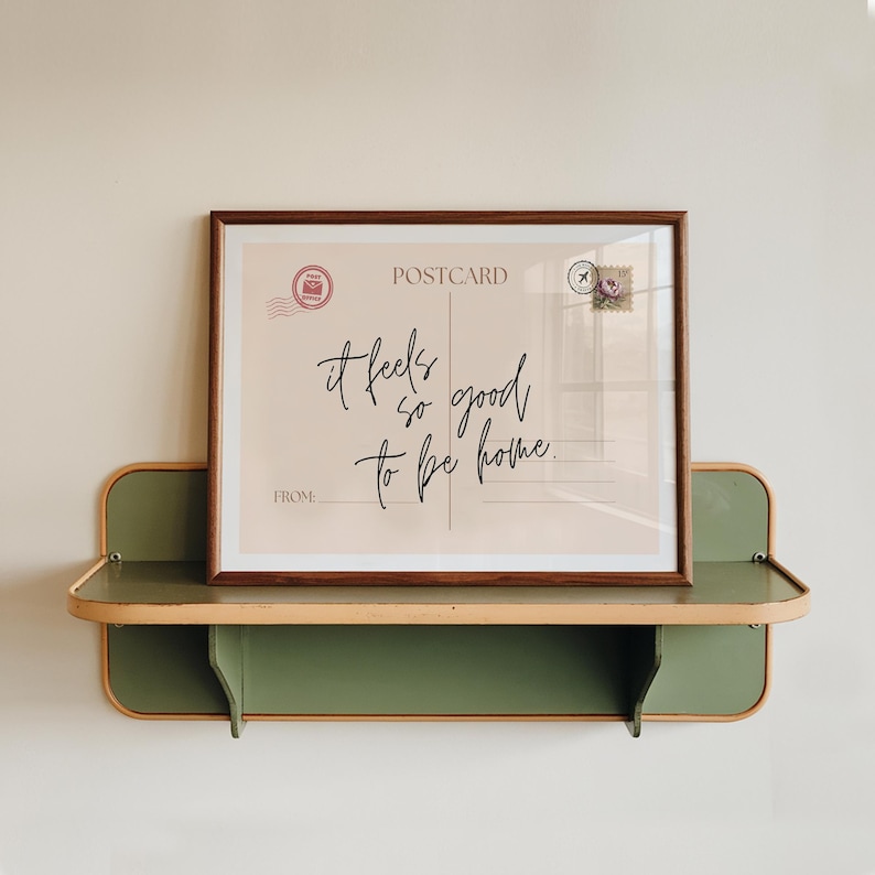 a vintage postcard style print, with the phrase it feels so good to be home