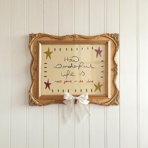 “Retro mid-century quote art print with stars and handwritten text reading ‘How wonderful life is now you’re in the world’ in warm vintage colours.”
