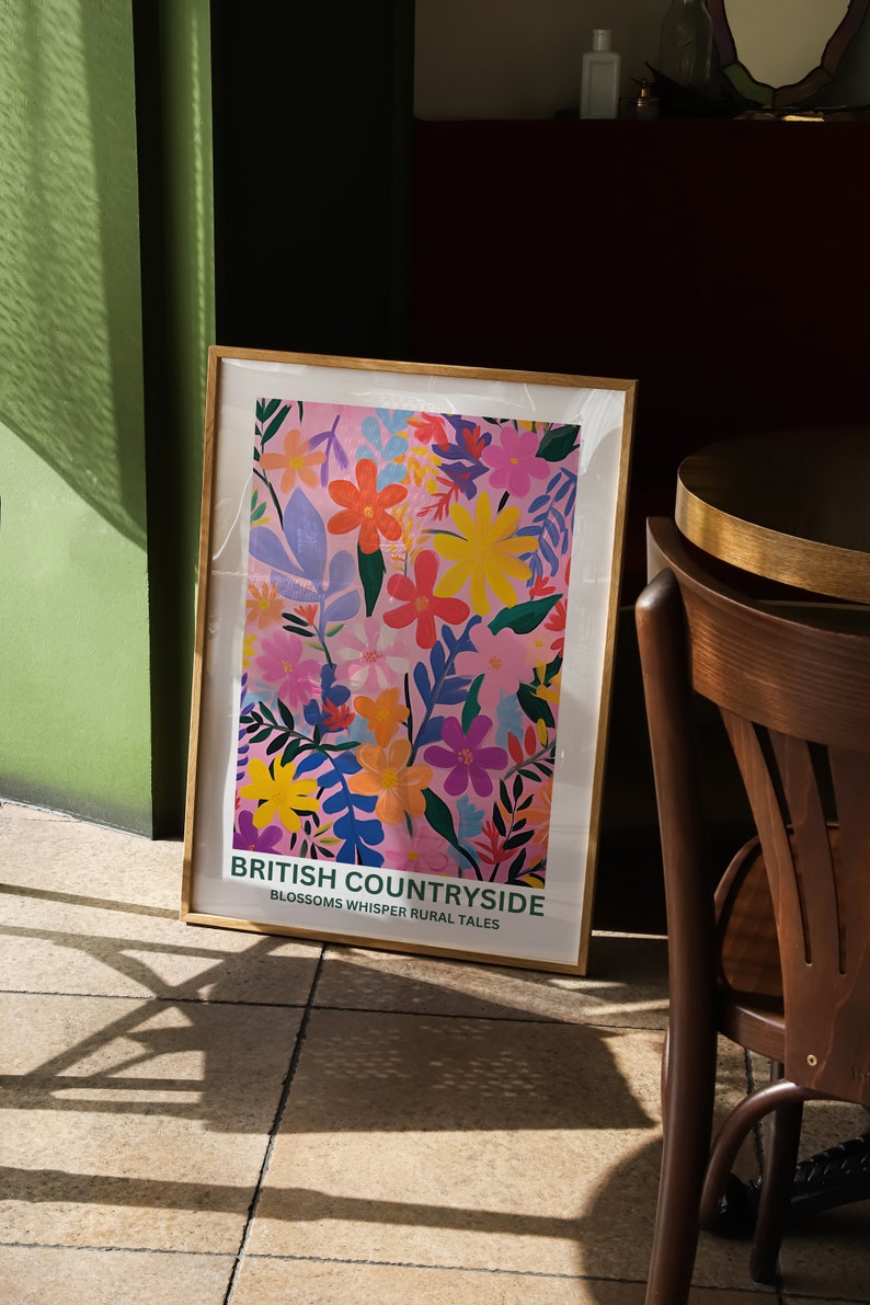 May include: A framed poster with a pink background and a colorful floral pattern. The poster has the text "British Countryside Blossoms Whisper Rural Tales".