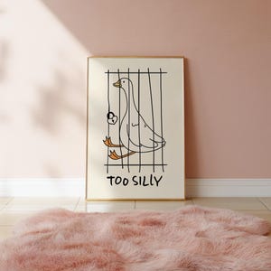 Bring a smile to your space with this Too Silly goose art print! A funny, minimalist illustration featuring a cheeky goose behind bars for being “too silly.” Perfect for adding personality to your home, office, or gallery wall.
This quirky silly goose animal print makes a wonderful gift for friends who love humor, cottagecore whimsy, or modern minimalist art. Designed to brighten up any corner and spark joy daily.