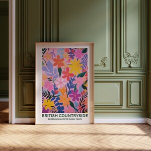 May include: A poster with a pink background and a colorful floral pattern. The text "BRITISH COUNTRYSIDE" is at the bottom of the poster, with the words "BLOSSOMS WHISPER RURAL TALES" below it.
