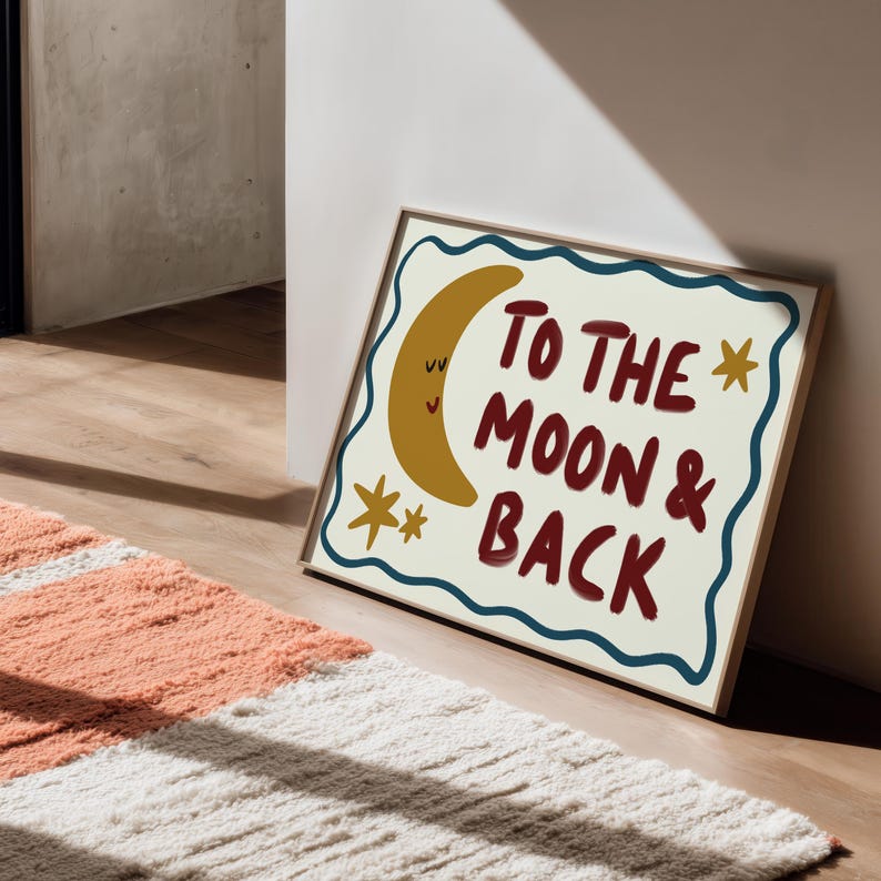 Hand-drawn children’s illustration featuring the phrase “To the Moon & Back” in bold, brush-style lettering with a soft, painterly texture. A smiling crescent moon with simple closed eyes appears beside the text, accompanied by small star shapes that add a gentle, playful feel. A wavy hand-drawn border frames the artwork, giving it a cosy, retro look. The overall style is warm, friendly and nostalgic, with an imperfect hand-painted aesthetic designed to feel comforting and child-friendly.
