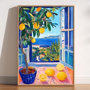 May include: A framed art print of a lemon tree in a blue pot, with lemons on the table. The painting depicts a coastal scene with a blue sea and sky visible through an open window. The artwork is in a vibrant, impressionistic style.