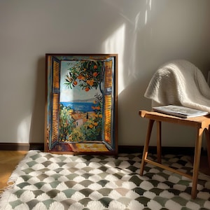 Add Mediterranean charm to your home with this vibrant Fauvism-style painting inspired by Henri Matisse. It features an open window overlooking the ocean, with a picturesque coastal view, including a little coastal village. Lush orange trees, the sea