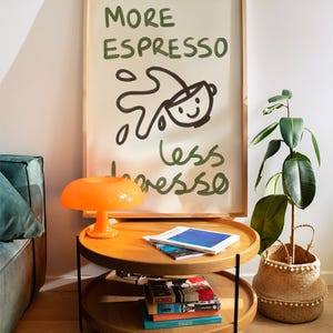 More espresso less depresso hand painted poster. The subtle brushstroke textures add an artistic flair, all set against a clean, beige background. Perfect for coffee enthusiasts, this chic,  creative poster is a stylish addition to modern apartments.