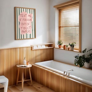 Funny bathroom wall art print with pink blob and wavy green stripes that reads “Text Me If You Run Out Of Toilet Paper”.