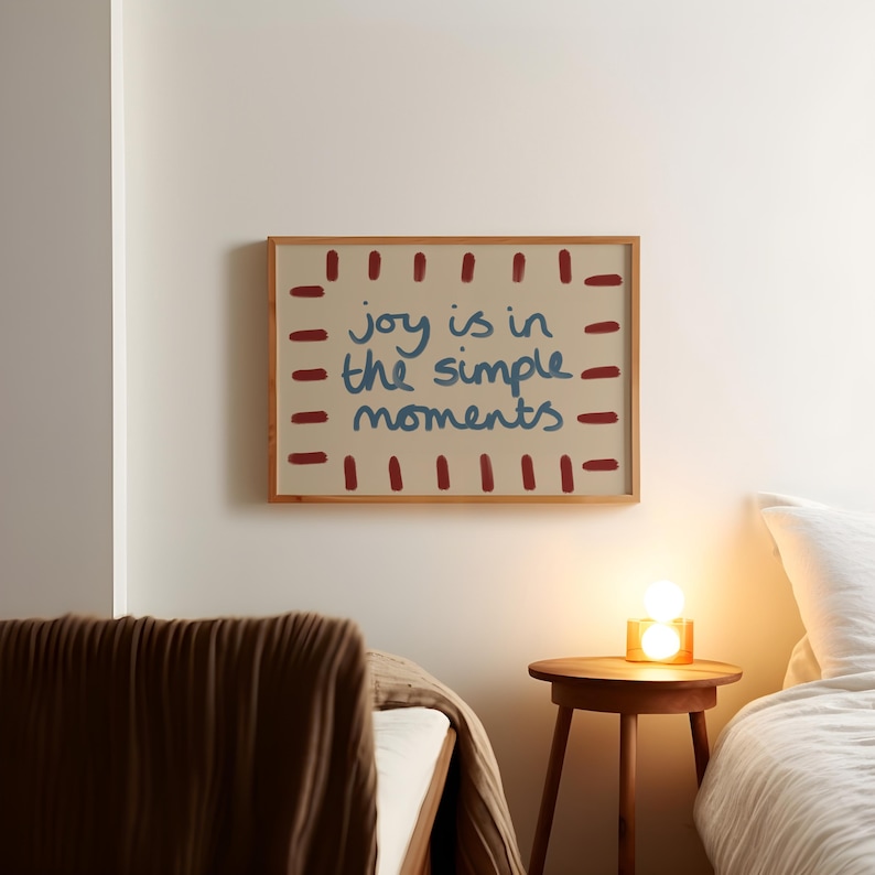 Celebrate the beauty of life’s simple pleasures with this "Joy Is in the Simple Moments" Hand-Drawn Typography Print. Featuring a retro mid-century design with red, blue and beige tones, this artwork embodies a laid-back, playful vibe perfect for a dopamine driven space.