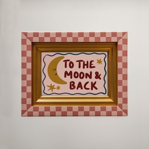 Hand-drawn children’s illustration featuring the phrase “To the Moon & Back” in bold, brush-style lettering with a soft, painterly texture. A smiling crescent moon with simple closed eyes appears beside the text, accompanied by small star shapes that add a gentle, playful feel. A wavy hand-drawn border frames the artwork, giving it a cosy, retro look. The overall style is warm, friendly and nostalgic, with an imperfect hand-painted aesthetic designed to feel comforting and child-friendly.
