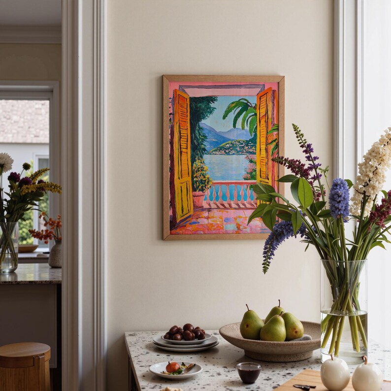 A Fauvist style painting inspired by Matisse, featuring a open patio doors overlooking a vibrant Italian landscape and Lake Como. The scene bursts with beautiful blue and pink tones: trees, mountains in the distance and the shimmering blue of the lake under a clear blue sky. The view captures the idyllic charm of summer by the water, with pots of flowers on the terrace and palm trees.