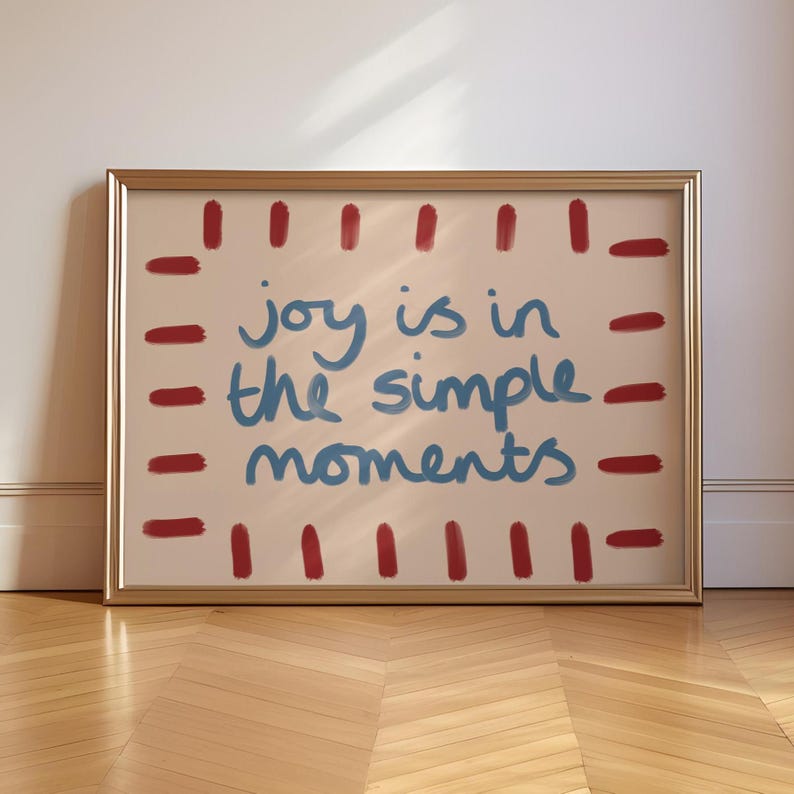 Celebrate the beauty of life’s simple pleasures with this "Joy Is in the Simple Moments" Hand-Drawn Typography Print. Featuring a retro mid-century design with red, blue and beige tones, this artwork embodies a laid-back, playful vibe perfect for a dopamine driven space.