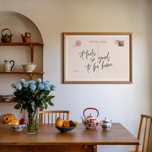 a vintage postcard style print, with the phrase it feels so good to be home