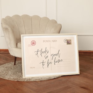 a vintage postcard style print, with the phrase it feels so good to be home