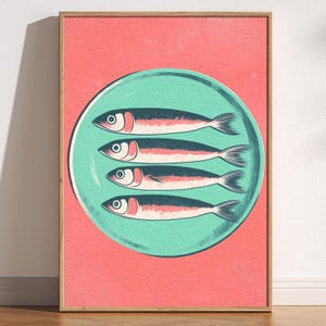 May include: A turquoise plate with four silver fish on a pink background. The fish are arranged in a row, with their tails pointing to the right.