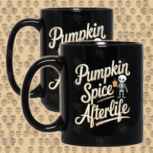 May include: Two black ceramic mugs with white text. The mug on the left says "Pumpkin" and the mug on the right says "Pumpkin Spice Afterlife" with a cartoon skeleton holding a cup of pumpkin spice.