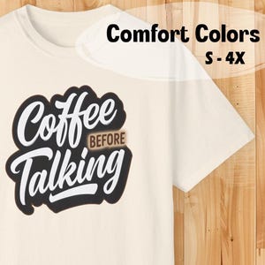 May include: White t-shirt with a black and white graphic that says "Coffee Before Talking". The text "Before" is in brown. The shirt is available in sizes S-4X.