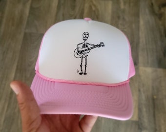 Skeleton Playing Guitar Pink Trucker Hat