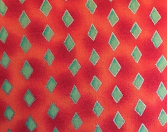 Serendipity fabric orange shade background, lime green diamond pattern by Marcus Brothers. Great for quilting fabric cut by the yard.
