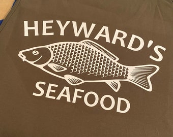 May include: A green tank top with a white graphic of a fish and the text "Heyward's Seafood".