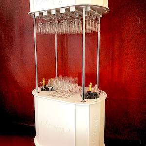 Champagne cart, drinks cart, candy cart, made from white plastic, holds up to 6 bottles of champagne.38 flutes/roof,up to 40 flutes on top