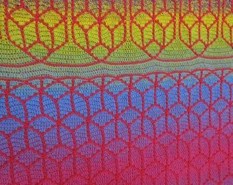 May include: A crocheted blanket with a gradient of red, pink, blue, green, and yellow. The blanket features a geometric pattern of red lines forming hexagons.