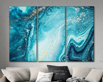 May include: A three-piece abstract art print set featuring a blue and gold marble design. The prints are framed and ready to hang.