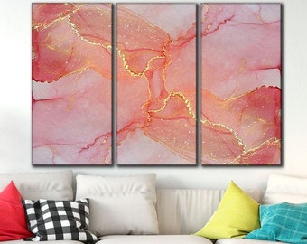 May include: A three-piece abstract canvas wall art set with pink and gold hues. The artwork features a marbled design with gold accents.