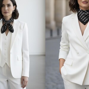 May include: A white suit with a matching vest and pants. The suit is paired with a black and white patterned scarf. The image shows a woman wearing the suit in a studio setting and outdoors.