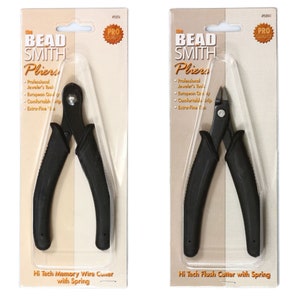 May include: Two pairs of black pliers with black handles and silver blades. The pliers on the left are labeled "Hi Tech Memory Wire Cutter with Spring". The pliers on the right are labeled "Hi Tech Flush Cutter with Spring".