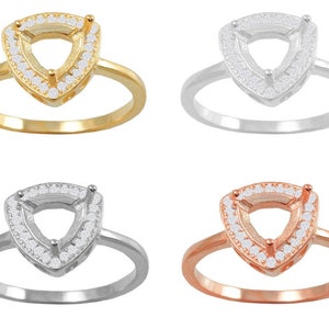 May include: Four engagement rings featuring a triangular setting with a halo of small diamonds. The rings are displayed in yellow gold, white gold, rose gold, and silver.