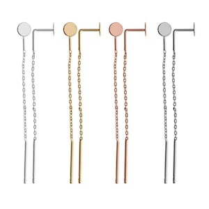 May include: Three pairs of dangle earrings with a small round disc at the top and a long chain that ends in a thin bar. The earrings are available in silver, gold, and rose gold.