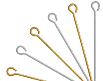 May include: A set of seven gold and silver head pins with loops. The pins are arranged in a fan shape.