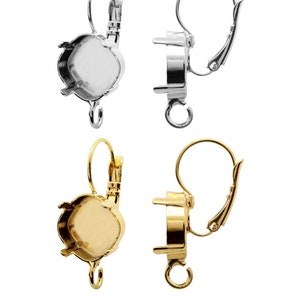 May include: Two pairs of earring settings, one silver and one gold. Each setting has a round bezel for a stone and a lever back closure.