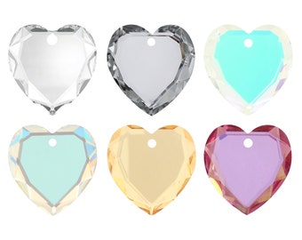 May include: Six heart-shaped crystal charms in various colors, including clear, gray, light blue, iridescent blue, gold, and purple. Each charm has a small hole at the top for hanging.