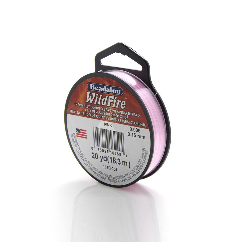 May include: A spool of pink Beadalon WildFire thermally bonded bead weaving thread. The spool is labeled with the brand name, product name, color, and size: 0.006 inches (0.15 mm), 20 yards (18.3 meters).