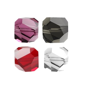 May include: Four faceted glass beads in different colors: purple, black, red, and clear.