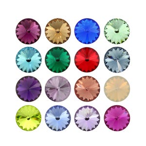May include: A collection of sixteen circular, faceted crystals arranged in a four-by-four grid. Each crystal features a starburst pattern radiating from the centre, displaying a variety of colours including purple, gold, blue, green, red, and pink.